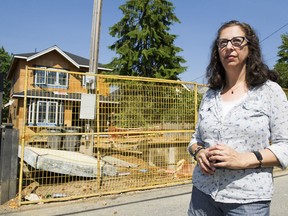 Roanna Zuker in the alley behind the house under construction on the 2600-block of Trinity Street in Vancouver that resulted in the removal of a tree.
