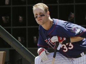 In this July 21, 2013, file photo, Minnesota Twins' Justin Morneau waits his turn to bat in the first inning of a baseball game against the Cleveland Indians in Minneapolis. Morneau, will appear at Nat Bailey on Tuesday as part of the Superstar Series at the Nat.