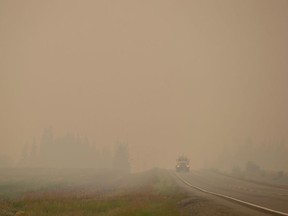 Thick smoke from wildfires fills the air as a motorist travels on Hwy. 27 between Vanderhoof and Fort St. James, B.C., on Wednesday, August 15, 2018.