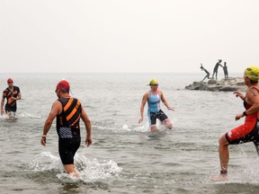 The Super League Triathalon debuts under a smokey haze in Penticton, B.C., on Saturday, August 18, 2018 as athletes compete in the equalizer stage swim in Okanagan Lake.