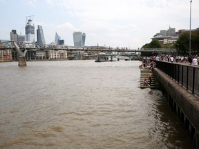 Tourists and Londoners along the Thames River.