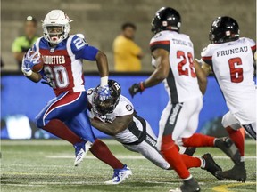 Running back Tyrell Sutton breaks away from Ottawa Redblacks defenders during an Alouettes game in July. The veteran has been traded by Montreal to the B.C. Lions.