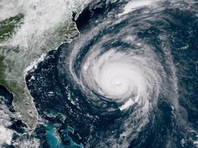 In this satellite image provided by U.S. National Oceanic and Atmospheric Administration (NOAA), Hurricane Florence churns through the Atlantic Ocean toward the U.S. East Coast on September 12, 2018.