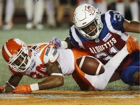 William Stanback of the Montreal Alouettes and Anthony Orange of the B.C. Lions keep their eyes on a loose ball during Friday's CFL action in Montreal.