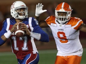 Montreal Alouettes quarterback Antonio Pipkin runs away from BC Lions's Shawn Lemon (9) during first half CFL action in Montreal on Sept. 14. Lemon has seven sacks in his last five games, most in the CFL.