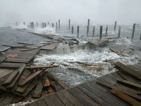 Portions of a boat dock and boardwalk are destroyed by powerful wind and waves as Hurricane Florence arrives September 13, 2018 in Atlantic Beach, United States. Coastal cities in North Carolina, South Carolina and Virginia are under evacuation orders as the Category 2 hurricane approaches the United States.