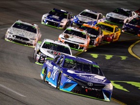 Martin Truex, driver of the #78 Auto-Owners Insurance Toyota, leads a pack of cars during the Monster Energy NASCAR Cup Series Federated Auto Parts 400 at Richmond Raceway on September 22, 2018 in Richmond, Virginia.