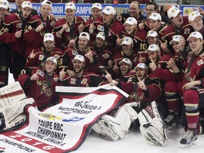 The West Kelowna Warriors pose with their championship banner and trophy after winning the 2016 Royal Bank Cup in Lloydminster Alta. on Sunday May 22, 2016. The Warriors fired their hockey boss on Monday only to rehire him on Thursday.