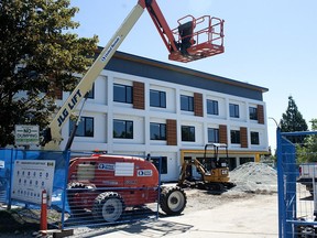 A unit of prefabricated, stacked housing units goes up in Vancouver.