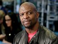 In this April 10, 2018 file photo, actor Terry Crews appears on the floor of the New York Stock Exchange in New York. Crews and agent Adam Venit have agreed to settle a lawsuit in which Crews alleged Venit groped him at a Hollywood party. Venit’s agency William Morris Endeavor, also named as a defendant, confirmed the deal Thursday in a statement saying the lawsuit would be dismissed.