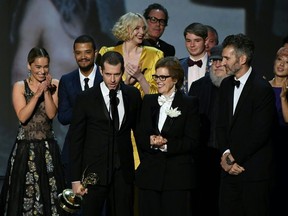 Writer-producer D.B. Weiss (C-L) and the cast of "Game of Thrones" accept the award Outstanding Drama series onstage during the 70th Emmy Awards at the Microsoft Theatre in Los Angeles, California on September 17, 2018.