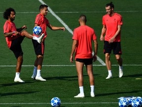 Brazilians Marcelo and Casemiro, French forward Karim Benzema and Welsh forward Gareth Bale (left to right), all of Real Madrid, enjoy a training session in Madrid on Sept. 18, 2018, ahead of their UEFA Champions League group match against visiting AS Roma.