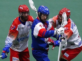 Peterborough Lakers Zach Currier and teammate Matt Gilray pressure former Laker Curtis Dickson of Maple Ridge Burrards during Game 2 action of the Mann Cup on Saturday in Peterborough.