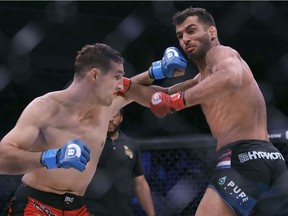 Rory MacDonald, left, trades punches with Gegard Mousasi during a middleweight world title mixed martial arts bout at Bellator 206 in San Jose, Calif., Saturday, Sept. 29, 2018. Mousasi won by technical knockout in the second round to retain the title.