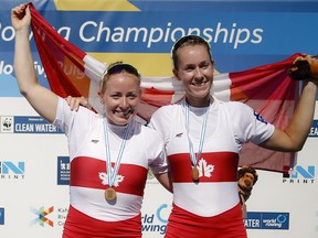 Gold medallists Canada's Caileigh Filmer, right, and Hillary Janssens pose with Canada's flag after winning in the Women's Pair event at the World Rowing Championships in Plovdiv, Bulgaria, Saturday, Sept. 15, 2018.