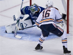Vancouver Canucks goalie Anders Nilsson stops a shot by Edmonton Oiler Jujhar Khaira during an exhibition game last week.