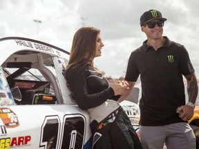 In this file image taken Feb. 11, 2018 and provided by Connexions Sports and Entertainment, NASCAR K&N Pro Series East driver Hailie Deegan shares a laugh with her father Brian Deegan at the New Smyrna Speedway in New Smyrna Beach Fla.