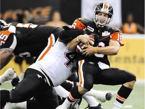 File: BC Lions QB #16 Buck Pierce is sacked by Calgary Stampeders #42 Mike Labinjo during the 1st quarter CFL action on Friday in Vancouver on the 24th of July 2009.
