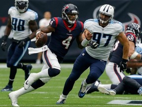 Texans QB Deshaun Watson (4) rushes with the ball as Karl Klug (97) of the Titans pursues during NFL action in Houston on Oct. 1, 2017.