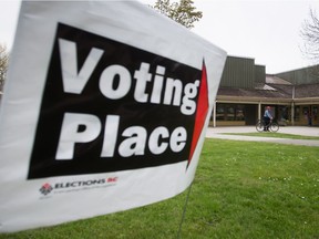 A voter arrives at a polling station on a bike to cast their ballot in the provincial election in the riding of Vancouver-Fraserview on May 9, 2017.