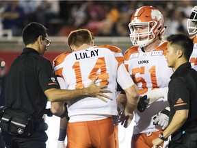 B.C. Lions quarterback Travis Lulay (14) is helped off the field after being injured during first half CFL football action against the Montreal Alouettes in Montreal, Friday, September 14, 2018.
