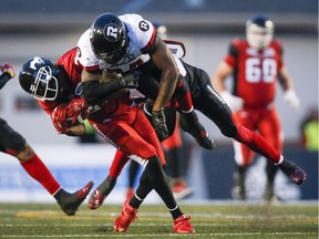 Ottawa Redblacks' Kyries Hebert, right, slams into Calgary Stampeders' DaVaris Daniels, during second half CFL football action in Calgary, Thursday, June 28, 2018. Ottawa Redblacks linebacker Kyries Hebert will be watching Friday's game against the B.C. Lions from the sidelines again because of an illegal hit last week against Montreal.