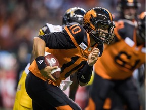 B.C. Lions quarterback Jonathon Jennings rushes for a first down against the Hamilton Tiger-Cats during the first half on Saturday at B.C. Place.
