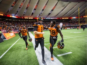 B.C. Lions kicker Ty Long, having one of the greatest seasons in team history, is congratulated by Micah Awe, right, and Jordan Herdman after kicking the winning field goal against the Hamilton Tiger-Cats on Saturday Sept. 22 at B.C. Place Stadium.