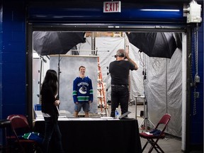 New Vancouver Canucks forward Antoine Roussel poses on Sept. 13 for his official headshot by team photographer Jeff Vinnick before the NHL squad's training camp.