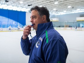 Vancouver Canucks head coach Travis Green watches players participate in a drill during NHL hockey training camp in Whistler, B.C., on Friday September 14, 2018.