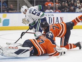 Bo Horvat is stopped by Oilers' goalie Cam Talbot  as Oscar Klefbom defends.