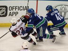 Brock Boeser and Oliver Ekman-Larsson go bump in the night on Saturday in Kelowna.