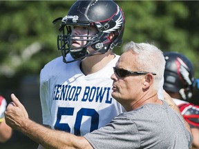 Terry Fox Ravens coach Martin McDonnell, right, and Matt Hewe-Baddege discuss strategy during a prep practise in Port Coquitlam on Sept. 5. The No. 2-ranked Ravens kick off their B.C. high school schedule Friday with a game against Abbotsford.