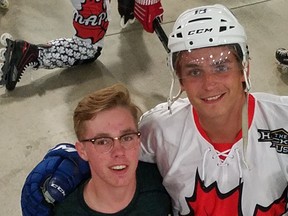 Vancouver Canucks winger Jake Virtanen (right) with young fan Miller Janzen, a Wisconsin native and big roller hockey player.