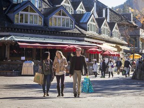 People enjoying Whistler village on  sunny fall day.