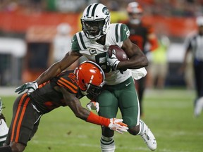 Cleveland Browns defensive back Damarious Randall (23) tackles New York Jets wide receiver Quincy Enunwa (81) during the first half of an NFL football game Thursday, Sept. 20, 2018, in Cleveland.