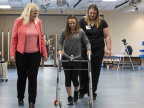 In this May 22, 2018 photo, Professor Susan Harkema watches as Kelly Thomas of Lecanto, Fla., practices walking with the help of a walker.