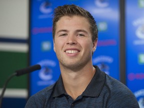 Ben Hutton is all smiles facing the Vancouver media on Thursday at Rogers Arena.