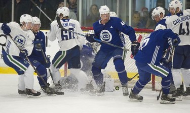 Erik Gudbranson trying to get in control of the puck during a scrimage at Vancouver Canucks 2018 training camp at the Meadow Park Sports Centre in Whistler, BC Saturday, September 15, 2018.