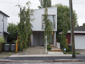 A thin house on St. George Street in Vancouver is listed for sale at $3 million. It has three bedrooms, three bathrooms, a study and library.