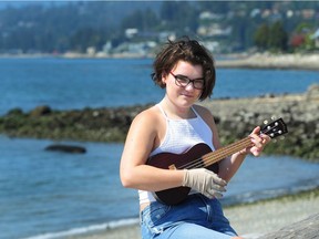 Sammy Badger, who goes by the stage name of Valor Grey, with her Ukulele in Dundarave Park in West Vancouver, BC., August 28, 2018. She survived a terrifying burn with 3rd and 4th degree burns to her face after a campfire sent a fireball her way. After music therapy helped her heal, she recorded and released a song called Phoenix to inspire others.