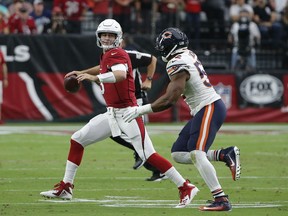 Arizona Cardinals quarterback Josh Rosen, left, looks to throw the ball as he is pressured by Chicago Bears linebacker Khalil Mack, right, during the second half of an NFL football game, Sunday, Sept. 23, 2018, in Glendale, Ariz.