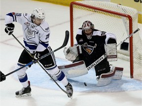 FILE PHOTO: Victoria Royals' Chaz Reddekopp (L) tips the puck past Vancouver Giants' goaltender David Tendeck during their WHL game at Save on Foods Memorial Centre in VICTORIA, B.C. April  3, 2018.