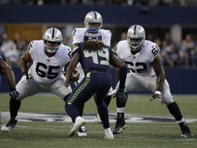 n this Aug. 30, 2018, file photo, Seattle Seahawks linebacker Shaquem Griffin (49) squares off against Oakland Raiders' Jordan Simmons (65) and James Stone (62) during the first half of an NFL football preseason game in Seattle. Griffin’s story will likely add another unplanned chapter on Sunday in Denver, one nobody could have expected on the day he was drafted by Seattle. He’ll do more than just play in his first NFL regular-season game. Griffin will be one of the starting linebackers for the Seahawks with K.J. Wright out due to minor knee surgery.