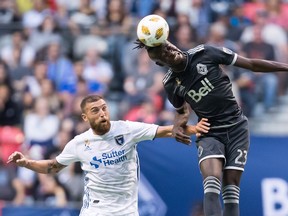Vancouver Whitecaps' Kei Kamara (23) gets his head on the ball above San Jose Earthquakes' Guram Kashia during the first half of an MLS soccer game in Vancouver, on Saturday September 1, 2018.