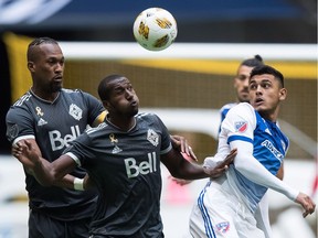 Kendall Waston of the Vancouver Whitecaps, left, questioned the timing and reasons for this week's firing of coach Carl Robinson. He blamed himself and his teammates for letting the bench boss down during an emotional news conference.