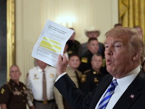 President Donald Trump responds to a reporters question during an event with sheriffs in the East Room of the White House in Washington, Wednesday, Sept. 5, 2018.