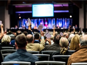 Delegates vote at a Union of B.C. Municipalities conference plenary session.