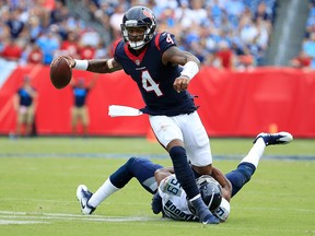 Deshaun Watson of the Houston Texans runs with the ball against Wesley Woodyard of the Tennessee Titans at Nissan Stadium on September 16, 2018 in Nashville. (Andy Lyons/Getty Images)
