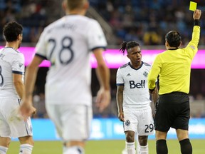Referee Baldomero Toledo shows Vancouver Whitecaps midfielder Yordy Reyna the yellow card during an Aug. 25 game at Avaya Stadium against the San Jose Earthquakes.